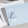 Contemporary wedding invitation featuring the couple’s initials shown with a coordinating envelope liner