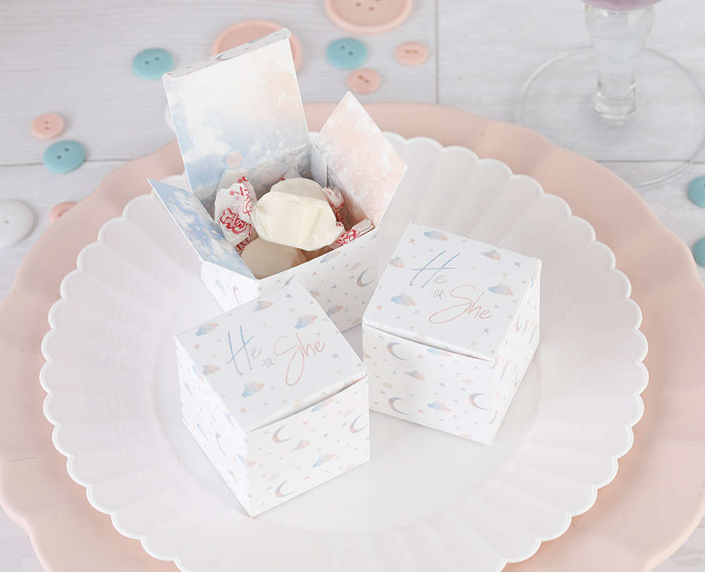 Baby shower favor boxes with a blue and pink moon and stars design