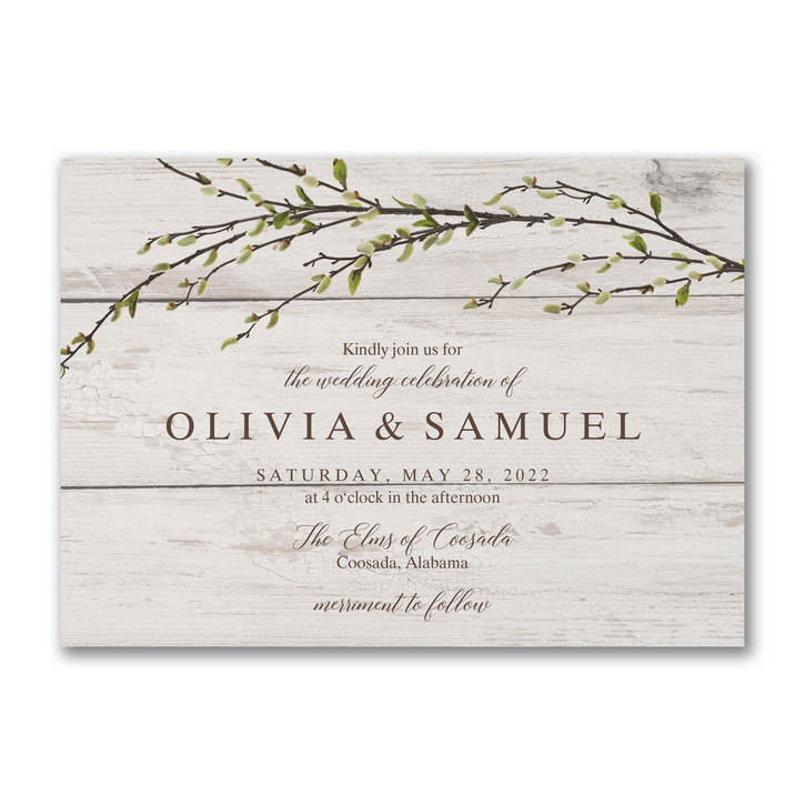 Rustic wedding invitation featuring a greenery design on a whitewash background