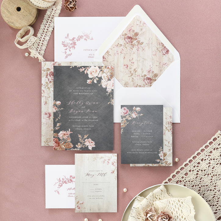 A pocket wedding invitation showcasing lovebirds perched on a leafy garland, pairs with a coordinating blue backer