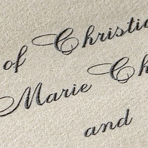 The raised ink on embossed wedding invitations provides a tactile experience