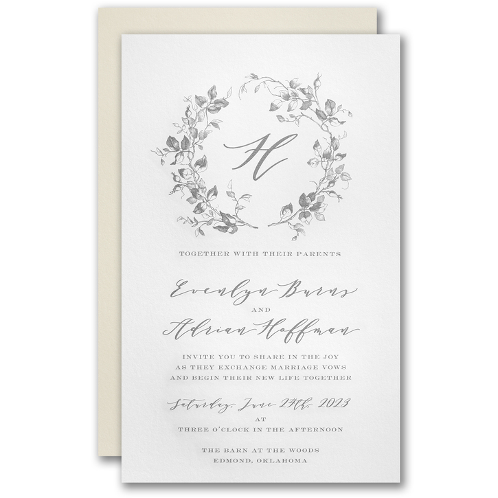 Traditional engraved wedding invitation with a wreath design enclosing a single initial