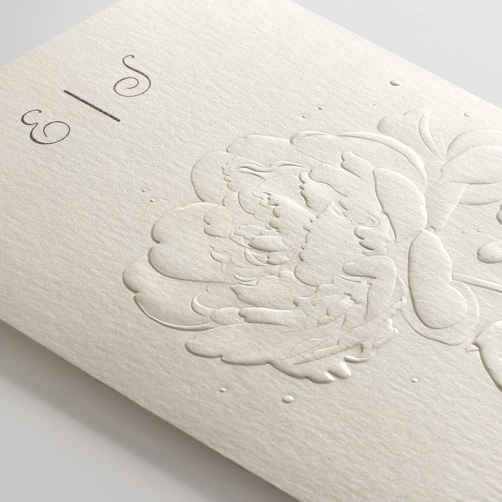 Trifold wedding invitation printed on shimmer paper, blind embossed with a peony design