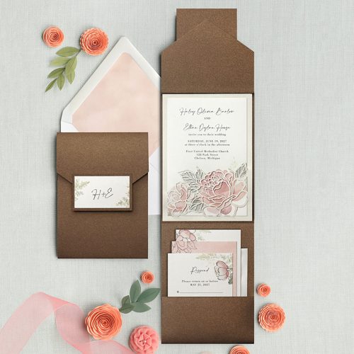 Shimmer paper pocket wedding invitation with pastel floral design accented with a layer of laser cut peonies
