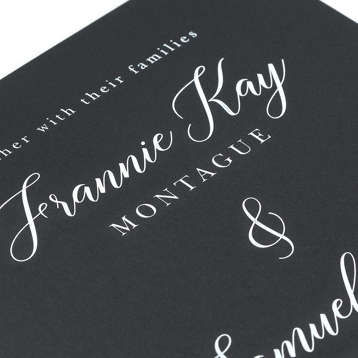 Engraved wedding invitation featuring dark paper printed with white ink
