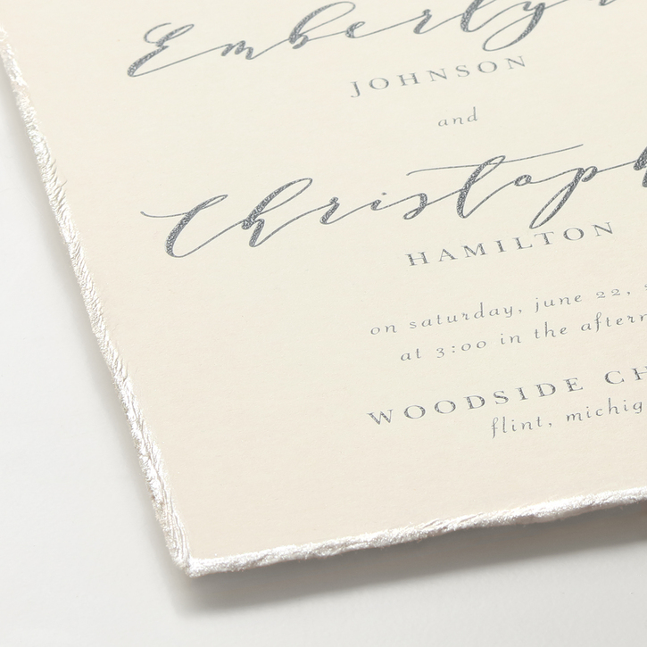 Classic wedding invitation featuring a deckle edge and wording printed in raised thermography ink.