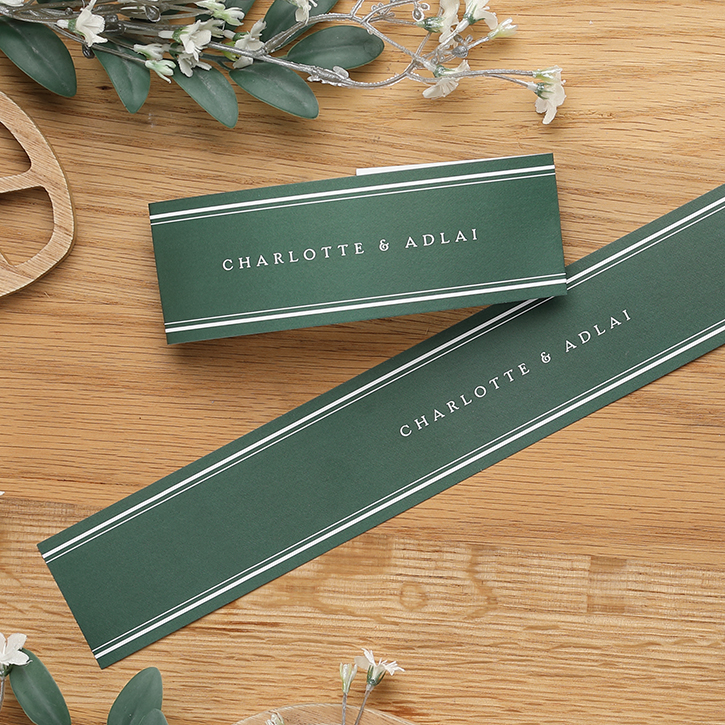 A hunter green belly band is shown personalized with the wedding couple's first names. 