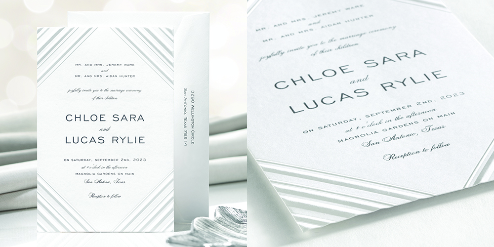 A luxe wedding invitation with dramatic blind embossed lines along the corners with thermography wording.