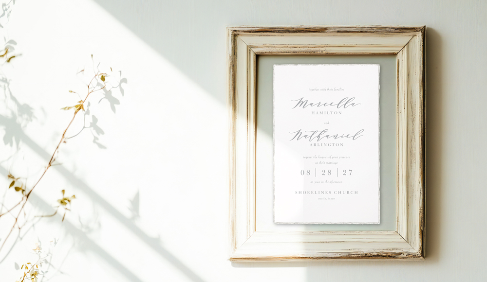 An extra wedding invitation is framed and hung as a wedding invitation keepsake.