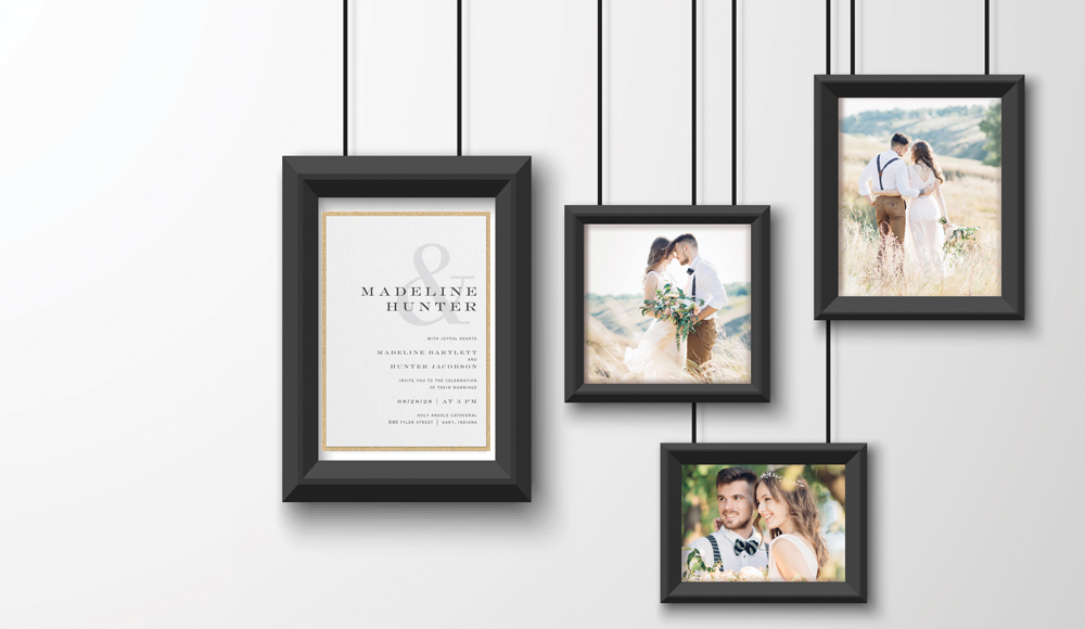 A wedding invitation keepsake made of a framed invitation with framed pictures hanging on a wall. 