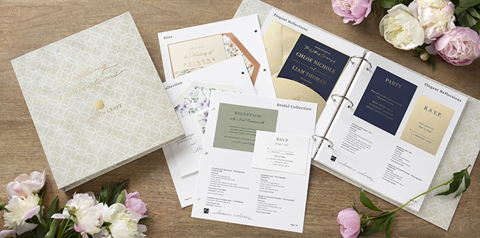 Classic Colors Wedding Collection binder open on a wooden table with a gold and navy invitation showing.